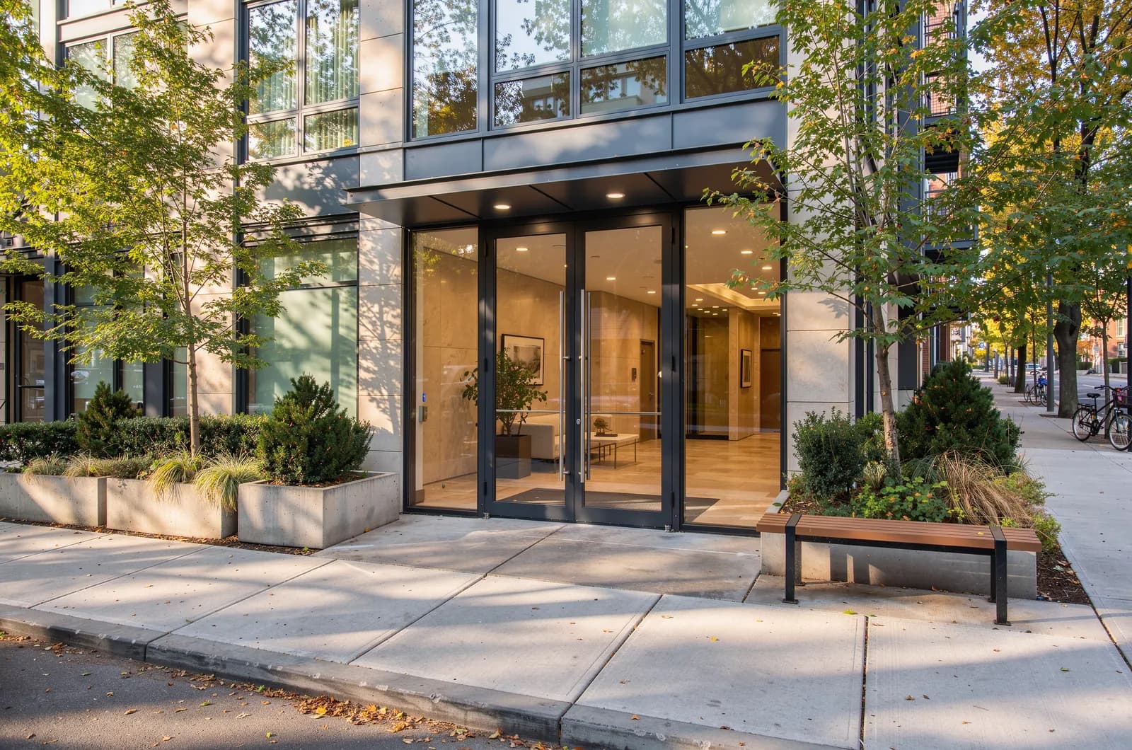 Entrance of a residential apartment building on a tree-lined street