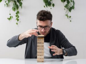 Man balancing wooden block game.