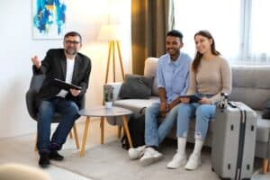 Consultant providing guide to full-service vacation rental management to a couple