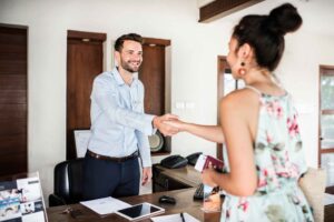 Rental manager greeting a client warmly