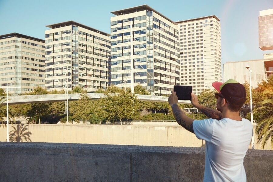 Man photographing urban rentals