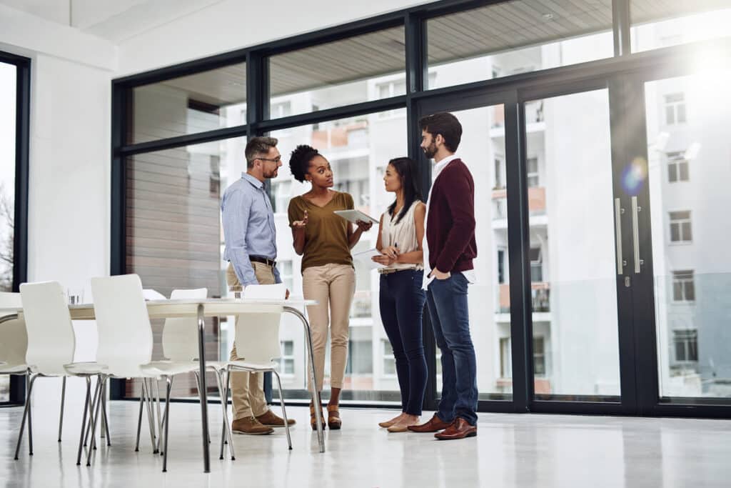 Shot of a group of businesspeople having a discussion in a modern office.