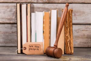 Books and gavel with 'We the People'