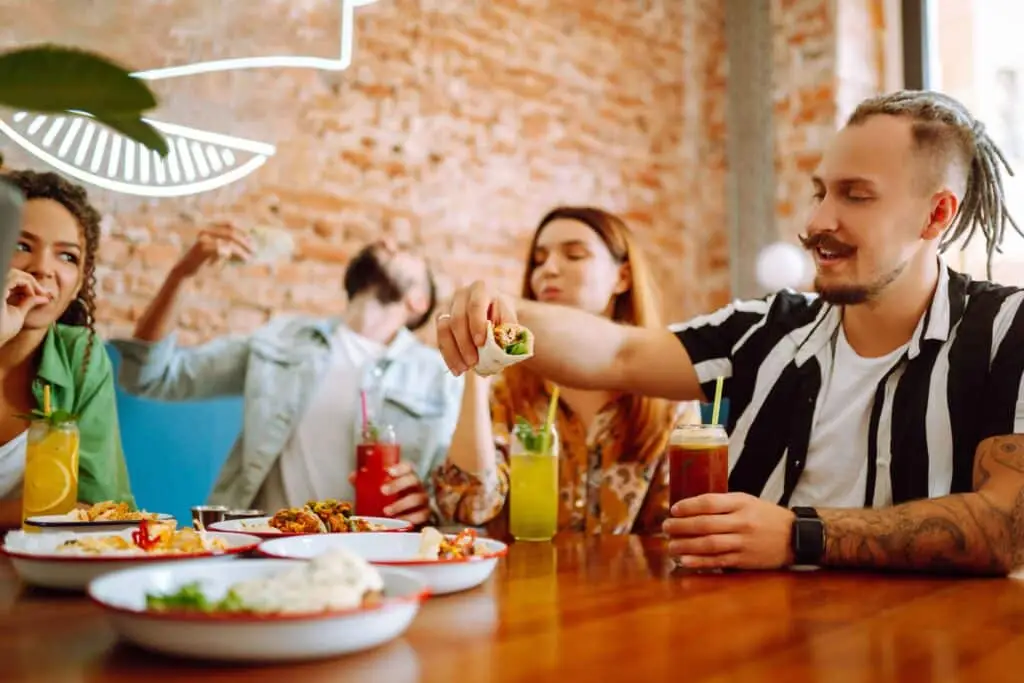 Group of friends enjoying a meal together at Flinders Lane Kitchen & Bar with a relaxed atmosphere.